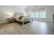 A spacious main bedroom with a tray ceiling, large windows and wood-look flooring at 783 Phil Haven Ln, Kennesaw, GA 30152