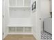 Mudroom with a built in storage bench and coat hooks with decorative tile flooring at 783 Phil Haven Ln, Kennesaw, GA 30152