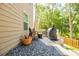 Outdoor patio area featuring gravel, Adirondack chairs, a grill, and outdoor decor at 783 Phil Haven Ln, Kennesaw, GA 30152