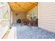 Relaxing covered patio area with a dining table, chairs, and stone flooring at 783 Phil Haven Ln, Kennesaw, GA 30152