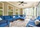 Inviting screened porch with comfortable blue seating, an area rug, and outdoor ceiling fan at 783 Phil Haven Ln, Kennesaw, GA 30152