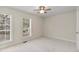 Spacious carpeted bedroom with two bright windows and a ceiling fan at 1004 Masons Creek Cir # 1004, Atlanta, GA 30350