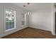 Bright dining room with wood floors, natural light, and contemporary light fixture at 1004 Masons Creek Cir # 1004, Atlanta, GA 30350