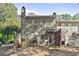 View of the rear of the house and backyard with a small deck and fence at 1004 Masons Creek Cir # 1004, Atlanta, GA 30350
