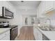 Bright kitchen featuring stainless steel appliances and white cabinets at 1004 Masons Creek Cir # 1004, Atlanta, GA 30350