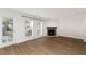 Spacious living room with fireplace, wood flooring, natural light, and a patio door at 1004 Masons Creek Cir # 1004, Atlanta, GA 30350