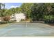 Community tennis court surrounded by lush trees at 1004 Masons Creek Cir # 1004, Atlanta, GA 30350