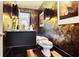 Elegant powder room featuring designer wallpaper, sconces, and a sleek, floating vanity at 1065 Peachtree Ne St # 3005, Atlanta, GA 30309