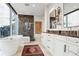 Modern bathroom featuring a soaking tub, walk-in shower, and double vanities at 1065 Peachtree Ne St # 3005, Atlanta, GA 30309