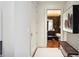 Hallway leading to a half-bath that has hardwood floors and decorative sconces at 1065 Peachtree Ne St # 3005, Atlanta, GA 30309