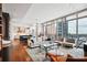 Spacious living room with hardwood floors, city views, and modern furnishings at 1065 Peachtree Ne St # 3005, Atlanta, GA 30309