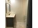 A sleek bathroom with modern fixtures, white marble floors, and a gray vanity at 1140 Smith Sw St, Atlanta, GA 30310