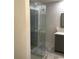 Bathroom with a glass shower door and a vanity with modern gray cabinetry at 1140 Smith Sw St, Atlanta, GA 30310