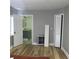 A bedroom with hardwood floors, closet with louvered doors, and an ensuite bathroom at 1140 Smith Sw St, Atlanta, GA 30310