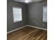 A cozy bedroom featuring hardwood floors and natural light from large windows at 1140 Smith Sw St, Atlanta, GA 30310