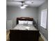 A cozy bedroom featuring hardwood floors and natural light from large windows at 1140 Smith Sw St, Atlanta, GA 30310