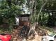 Charming home nestled among trees with a covered porch and natural landscaping at 1140 Smith Sw St, Atlanta, GA 30310