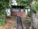 Charming home featuring a covered porch and an inviting entrance with a staircase at 1140 Smith Sw St, Atlanta, GA 30310