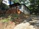 Charming home nestled among trees with a covered porch and natural landscaping at 1140 Smith Sw St, Atlanta, GA 30310