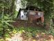 Charming home nestled among trees with a covered porch and natural landscaping at 1140 Smith Sw St, Atlanta, GA 30310
