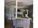 Beautiful gray kitchen featuring white countertops, an island with a gold faucet, and modern lighting at 1140 Smith Sw St, Atlanta, GA 30310