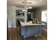 An efficient kitchen with an island featuring modern lighting and a breakfast bar at 1140 Smith Sw St, Atlanta, GA 30310