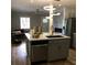 Open kitchen layout with an island, sink, countertop, stainless steel appliances, and modern lighting at 1140 Smith Sw St, Atlanta, GA 30310