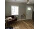 Cozy living room featuring a comfortable couch, hardwood floors, and natural light at 1140 Smith Sw St, Atlanta, GA 30310