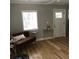 Cozy living room featuring a comfortable couch, hardwood floors, and natural light at 1140 Smith Sw St, Atlanta, GA 30310