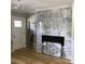Stylish living room featuring a fireplace with marble-look tile surround and hardwood floors at 1140 Smith Sw St, Atlanta, GA 30310