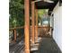 Outdoor porch area with a wooden railing and visible trees in a green and private outdoor space at 1140 Smith Sw St, Atlanta, GA 30310