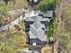 Aerial view of a home showcasing its architectural design, landscaping, and surrounding neighborhood at 6030 Chimney Springs Rd, Buford, GA 30518