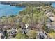 Aerial view of a wooded home with a private dock with lifts on the lake at 6030 Chimney Springs Rd, Buford, GA 30518