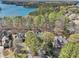 Aerial view of the neighborhood with lush trees and a serene lake backdrop at 6030 Chimney Springs Rd, Buford, GA 30518