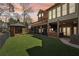 A beautiful backyard showcasing a covered hot tub, screened-in porch, and immaculate landscaping at 6030 Chimney Springs Rd, Buford, GA 30518