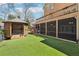 Backyard oasis includes a covered hot tub, manicured lawn, and screened-in porch at 6030 Chimney Springs Rd, Buford, GA 30518