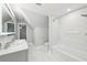 Bathroom with dual sinks, a tub-shower with tile surround and large white patterned floor tiles at 6030 Chimney Springs Rd, Buford, GA 30518