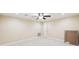 Bright bedroom featuring plush carpet, ceiling fan, and neutral walls at 6030 Chimney Springs Rd, Buford, GA 30518