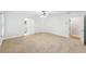 Large bedroom with neutral carpet, ceiling fan, and adjoining doorways to other rooms at 6030 Chimney Springs Rd, Buford, GA 30518