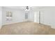 Spacious bedroom featuring neutral carpeting, large windows, and a ceiling fan at 6030 Chimney Springs Rd, Buford, GA 30518