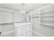 Walk-in closet with center island and custom shelving at 6030 Chimney Springs Rd, Buford, GA 30518