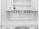 Built-in desk area with stylish white cabinetry, a marble countertop, and open shelving at 6030 Chimney Springs Rd, Buford, GA 30518