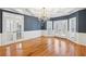 Elegant dining room featuring hardwood floors, wainscoting, coffered ceilings, and a chandelier at 6030 Chimney Springs Rd, Buford, GA 30518