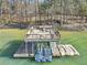 A large dock includes a sundeck, boat slips, and lights for lake enjoyment at 6030 Chimney Springs Rd, Buford, GA 30518