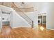 Spacious foyer showcasing a curved staircase, beautiful hardwood floors, and open layout at 6030 Chimney Springs Rd, Buford, GA 30518