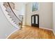 Bright foyer featuring a soaring ceiling, curved staircase, hardwood floors, and abundant natural light at 6030 Chimney Springs Rd, Buford, GA 30518