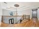 Foyer features hardwood floors, ornate railing, curved staircase, and a decorative chandelier at 6030 Chimney Springs Rd, Buford, GA 30518