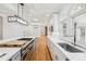 A gourmet kitchen features an expansive island, high-end appliances, custom cabinetry, and lots of natural light from large windows at 6030 Chimney Springs Rd, Buford, GA 30518
