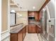 Galley kitchen with stainless steel appliances, granite counters, and hanging pendant lights above the bar at 6030 Chimney Springs Rd, Buford, GA 30518