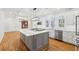 Elegant kitchen featuring a large island, stainless steel appliances, and hardwood floors at 6030 Chimney Springs Rd, Buford, GA 30518